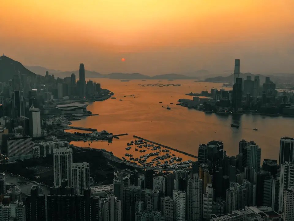 Hong Kong’s harbour from above at sunset, towers on both shores
