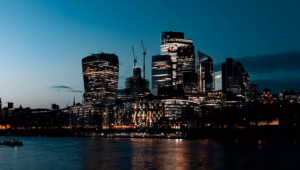 The City of London's towers across the Thames at dusk