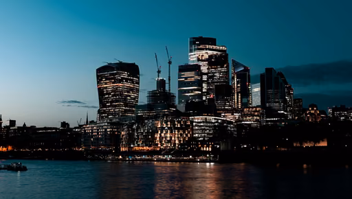 The City of London's towers across the Thames at dusk